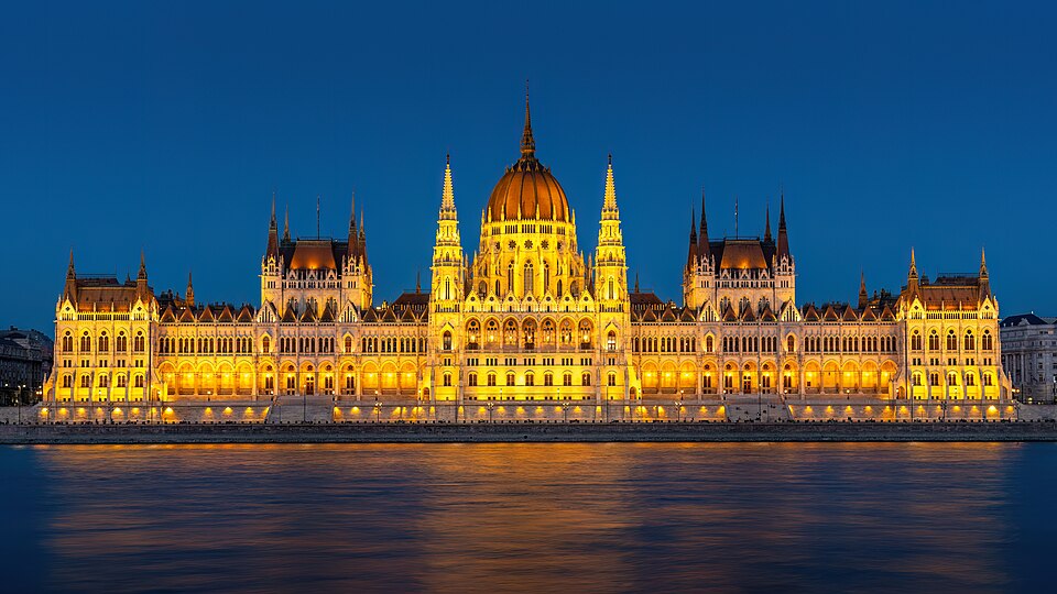 The Hungarian Parliament lit up at night, reflected in the Danube
