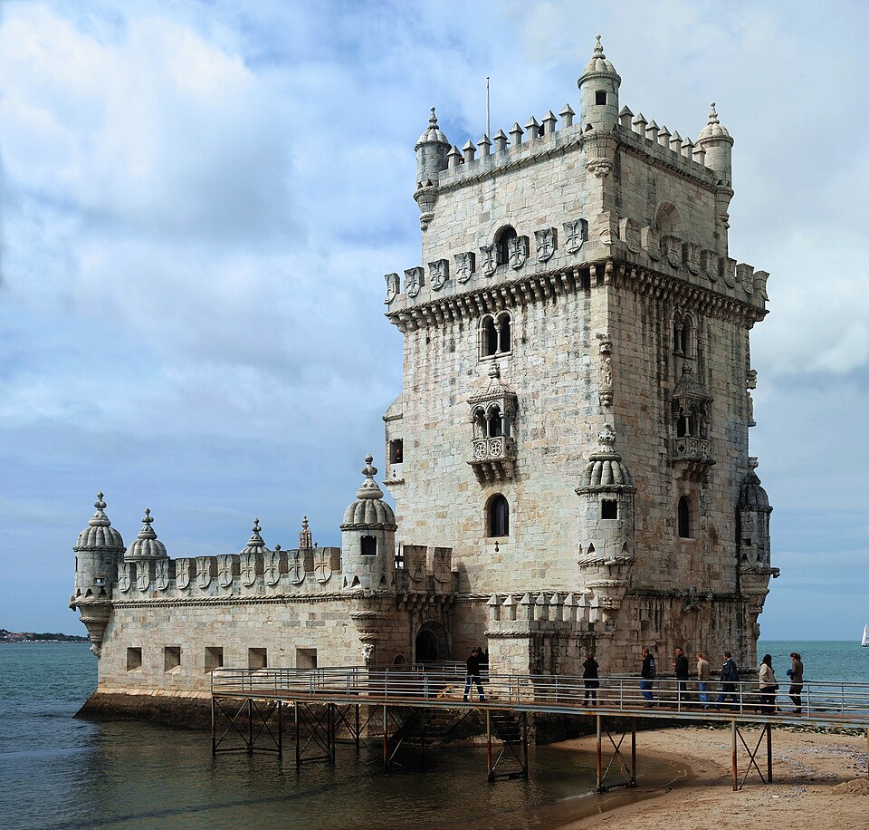 The Torre de Belém at the edge of the Tagus, people crossing the footbridge to it